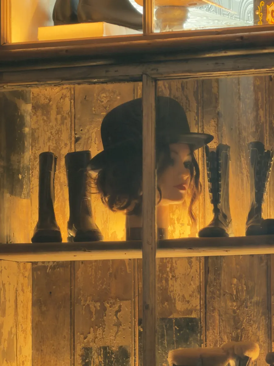 Vintage boots and hats in the restored display cabinet