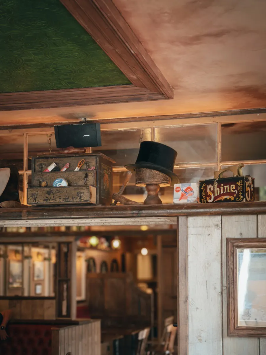 Top hat, vintage crates and curios on the high shelf